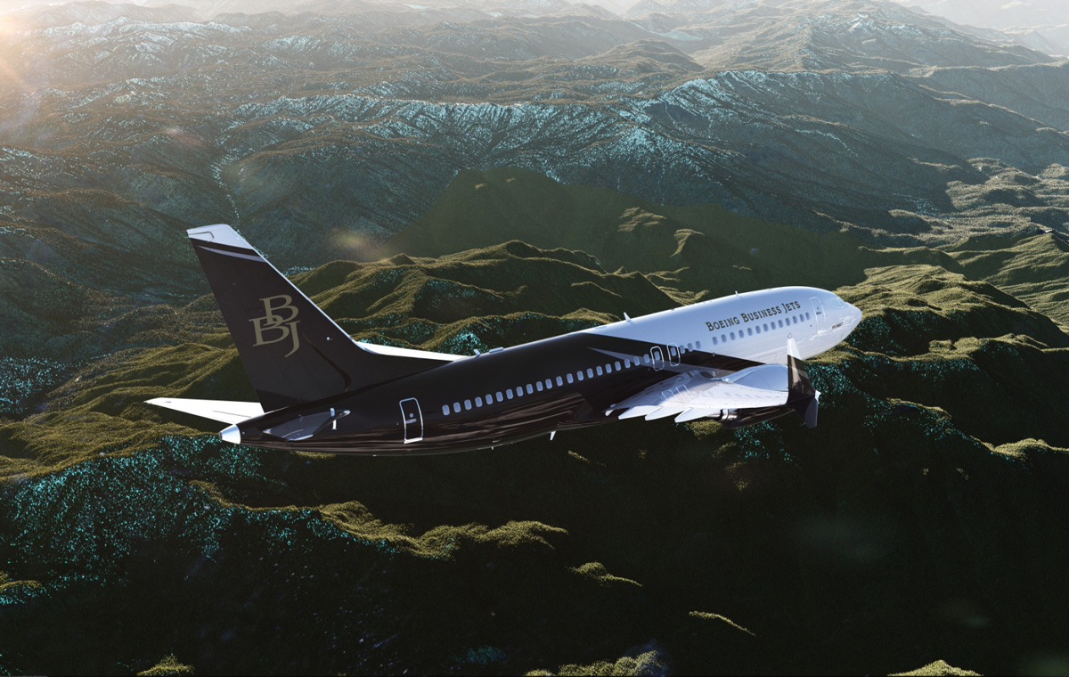 a BBJ jet flying over the mountains