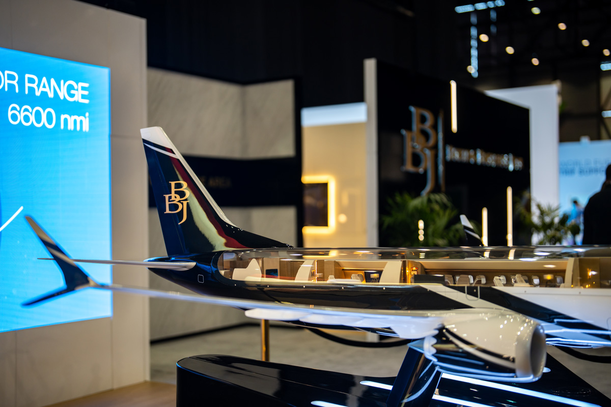 A miniature model of a BBJ 737 Max with a transparent top so viewers can see what is inside the plane's cabin.
